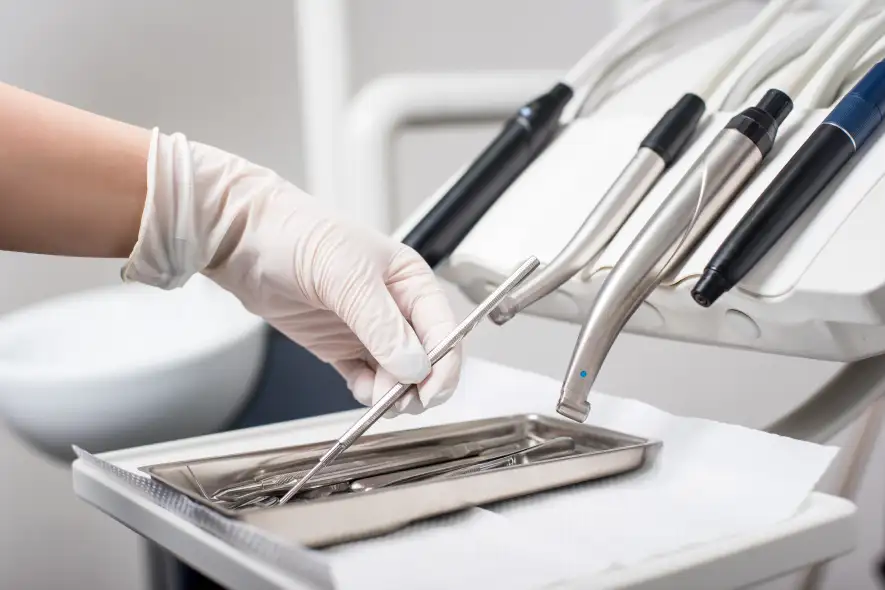 Stomatologické potreby, Dentálne pomôcky - dentist with gloved hand is picking dental tool in 2023 11 27 05 13 51 utc 236